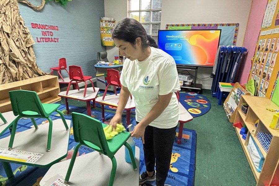 Clean preschool classroom with child-size tables and chairs