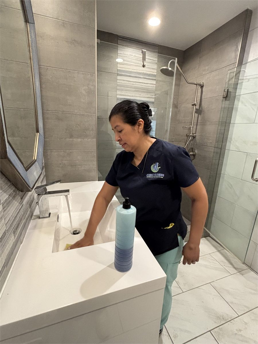 Starbiz cleaner detailing a glass shower enclosure
