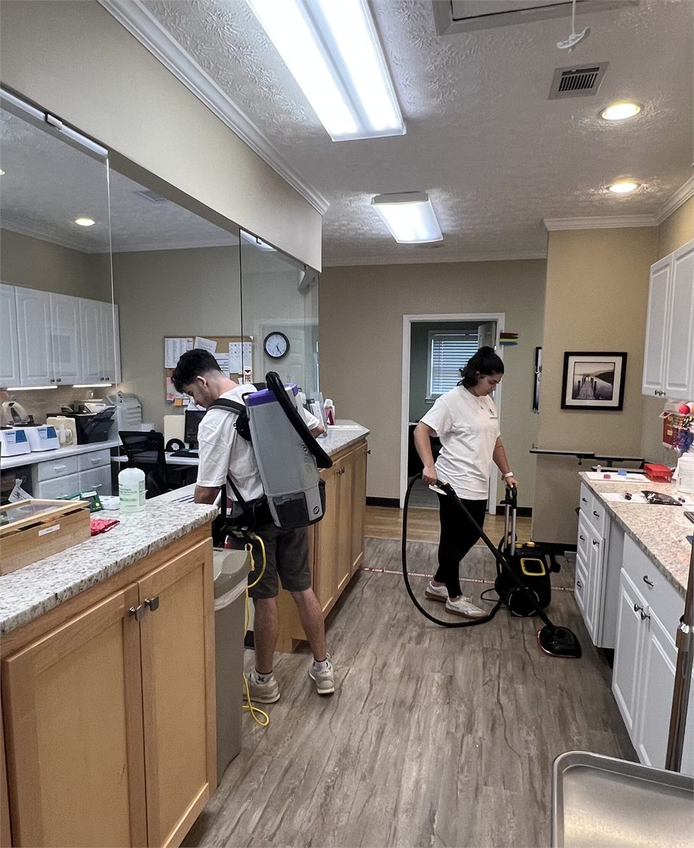 Starbiz cleaner vacuuming an office with a backpack vacuum