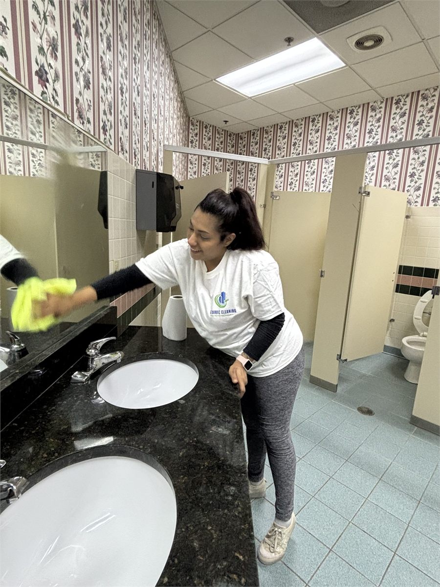 Starbiz cleaner mopping a hard floor in an office